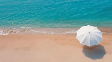 White Umbrella on Sandy Beach With Turquoise Water Under Clear Sky photo