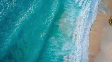 Serene Aerial View of Turquoise Waves Along Rugged Coastline in Daylight photo