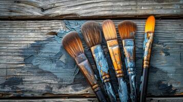 Group of Brushes on Wooden Table photo