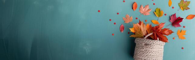 Autumn Leaves Falling From Basket Against Soft Blue Background photo