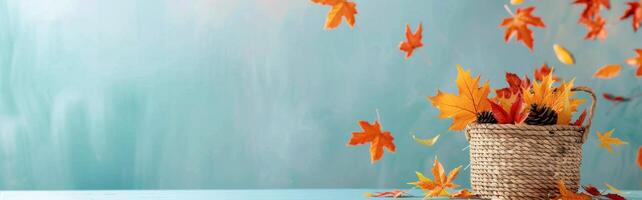 Autumn Leaves Falling From Basket Against Soft Blue Background photo