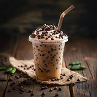 A Cup of Iced Coffee With Chocolate Chips on a Wooden Table photo