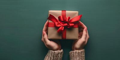 Person Holding Present Box With Red Bow photo