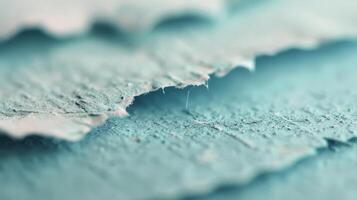 Close-Up View of Frayed Fabric Edge on Soft Blue Material photo