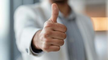Person Giving Thumbs Up In Office Setting During Daytime photo