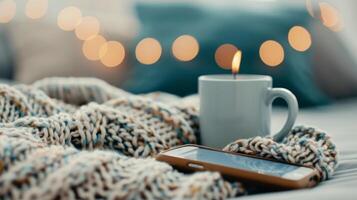 Smartphone Resting on Cozy Knitted Blanket With Warm Lights in Background photo