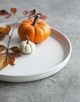Autumn Pumpkins and Maple Leaves on Neutral Plate Decor photo