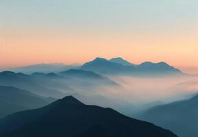 Breathtaking Sunrise Over Mountain Range With Soft Blue Haze in Early Morning photo