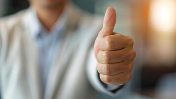 Person Giving Thumbs Up In Office Setting During Daytime photo