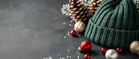 Green Knit Hat Surrounded by Christmas Ornaments and Snowflakes on Dark Background photo