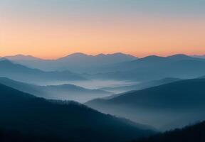 Serene Mountain Range at Dawn With Soft Mist and Gentle Hues photo