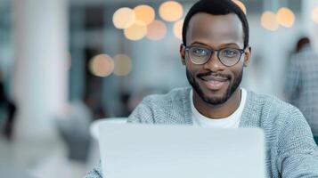 Young Man Working on Laptop in Modern Cafe During Daytime photo