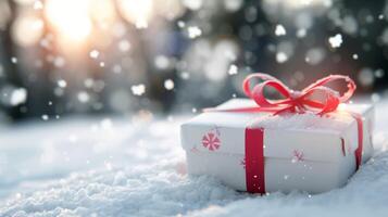 Wrapped Christmas Gift on Snowy Ground With Falling Snowflakes photo