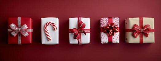 Festively Wrapped Holiday Gifts With Candy Cane on Red Background photo