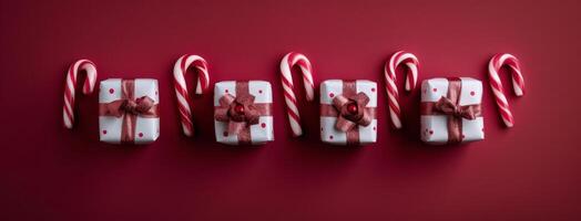 Festively Wrapped Holiday Gifts With Candy Cane on Red Background photo