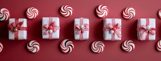 Festively Wrapped Holiday Gifts With Candy Cane on Red Background photo