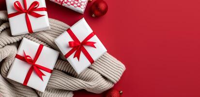 Festive Gift Boxes With Red Ribbons on Cozy Knit and Red Background photo