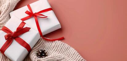 Festive Gift Boxes With Red Ribbons on Cozy Knit and Red Background photo
