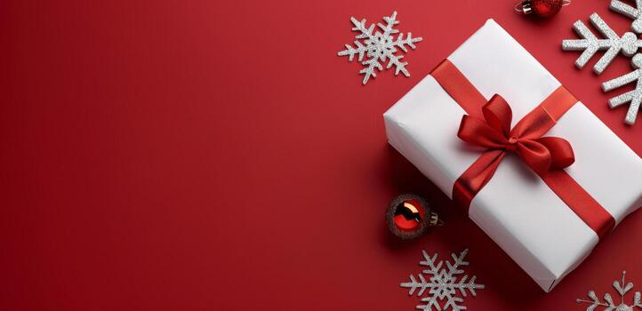 Festively Wrapped Gift Box With Red Bow on a Red Background With Snowflakes photo