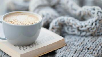 Cozy Autumn Moment With Hot Beverage, Knitted Blanket, and Leaves on a Table photo