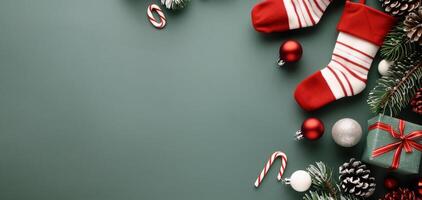 Christmas Stocking Surrounded by Decorations and Candy Canes on Dark Green Surface photo