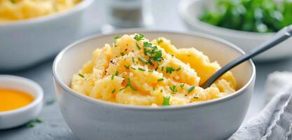 Creamy Mashed Potatoes Served in White Bowls With Seasoning on a Wooden Surface photo