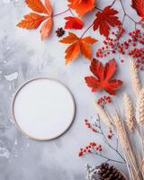 Fall Leaves Arranged Around A Round White Surface On A Gray Background photo