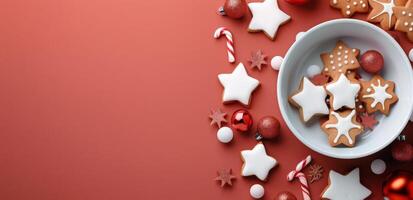 Festive Gingerbread Cookies and Decorations on Red Background During the Holiday Season photo