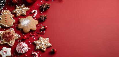 Festive Gingerbread Cookies and Decorations on Red Background During the Holiday Season photo