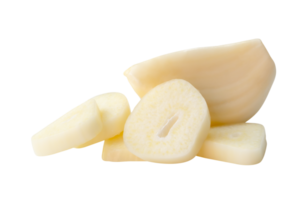 Side view of peeled white garlic cloves with slices or pieces in stack isolated with clipping path in file format png
