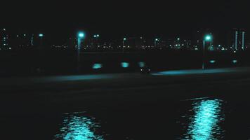 Flight from a height behind a rushing sports motorcycle along the river against the backdrop of the night city video