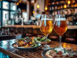 Two glasses of craft beer with assorted gourmet dishes on a wooden table in a cozy pub setting with warm lighting photo