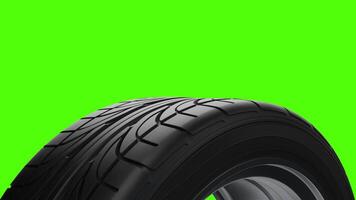 Loop Spinning car wheel on a green background video