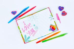 Notebook with stationery on a white table photo