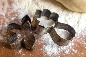 forms for squeezing the dough. dough on the table with dough tools. photo