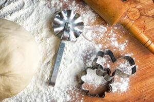 forms for squeezing the dough. dough on the table with dough tools. photo