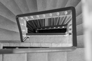 staircase with a railing and white steps the staircase is narrow and has a dark color photo
