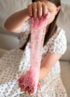 Girl Stretching Slime. Girl Playing with Pink Slime photo