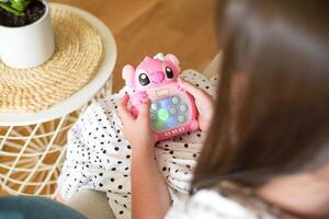Bialystok, Poland. July 04 2024. Child Playing Electric Pop It Game. Electric Pop It Joystick photo