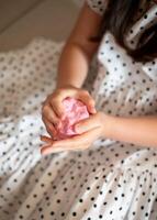 Girl Stretching Slime. Girl Playing with Pink Slime photo
