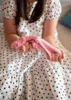 Girl Stretching Slime. Girl Playing with Pink Slime photo