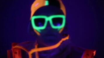 Man is dancing in neon clothes close up video
