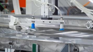 Fully automated machine designed for the purpose of separating and transporting metal sheets in industrial settings. Close up. Slow motion video