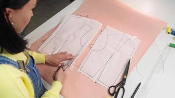 Designer has combined two separate drawings into one to create a collar design for their clothing. Top view video