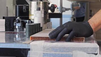 Process of affixing adhesive tape to the extremity of a piece of furniture at the manufacturing facility. video