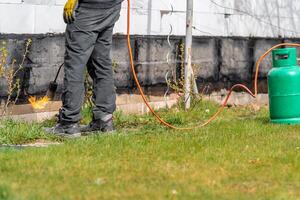 craftsman with a gas tank for a fire on a construction site photo