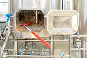 cleaning the boiler from residual malt after brewing beer in the brewery. top view photo