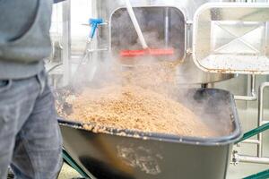 cleaning the boiler from residual malt after brewing beer in the brewery photo