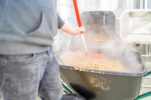 cleaning the boiler from residual malt after brewing beer in the brewery photo