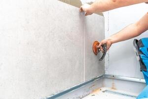 craftsman tiling the room with large format tiling photo